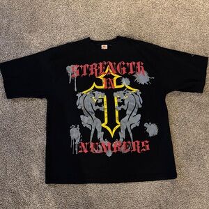 Black Graphic T-Shirt with Red Lettering and Yellow Cross Design